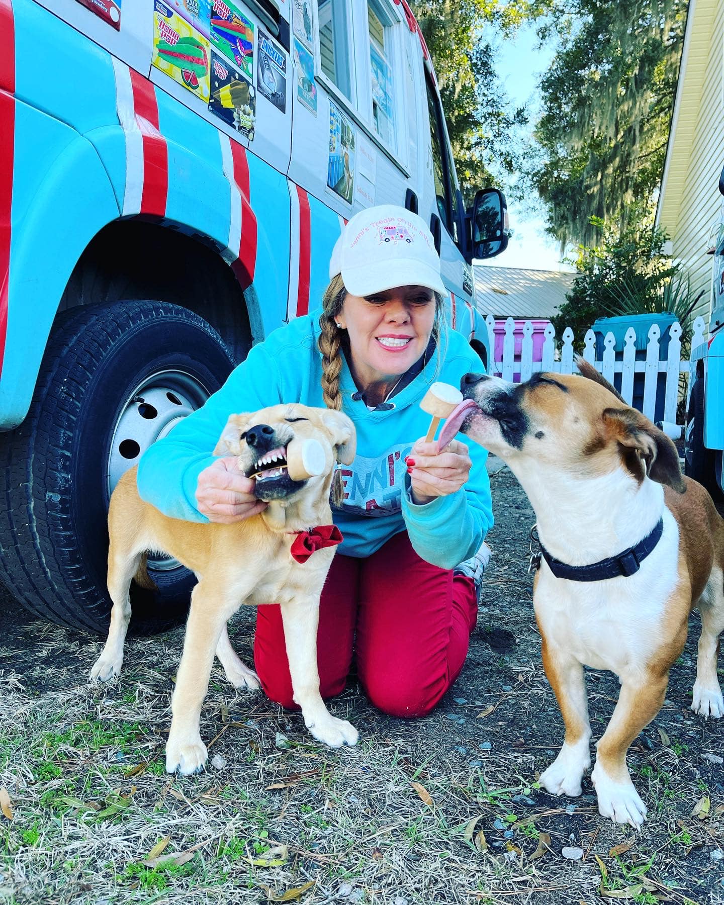 two dogs eating pupsicles from Birdie Lu's ice cream truck